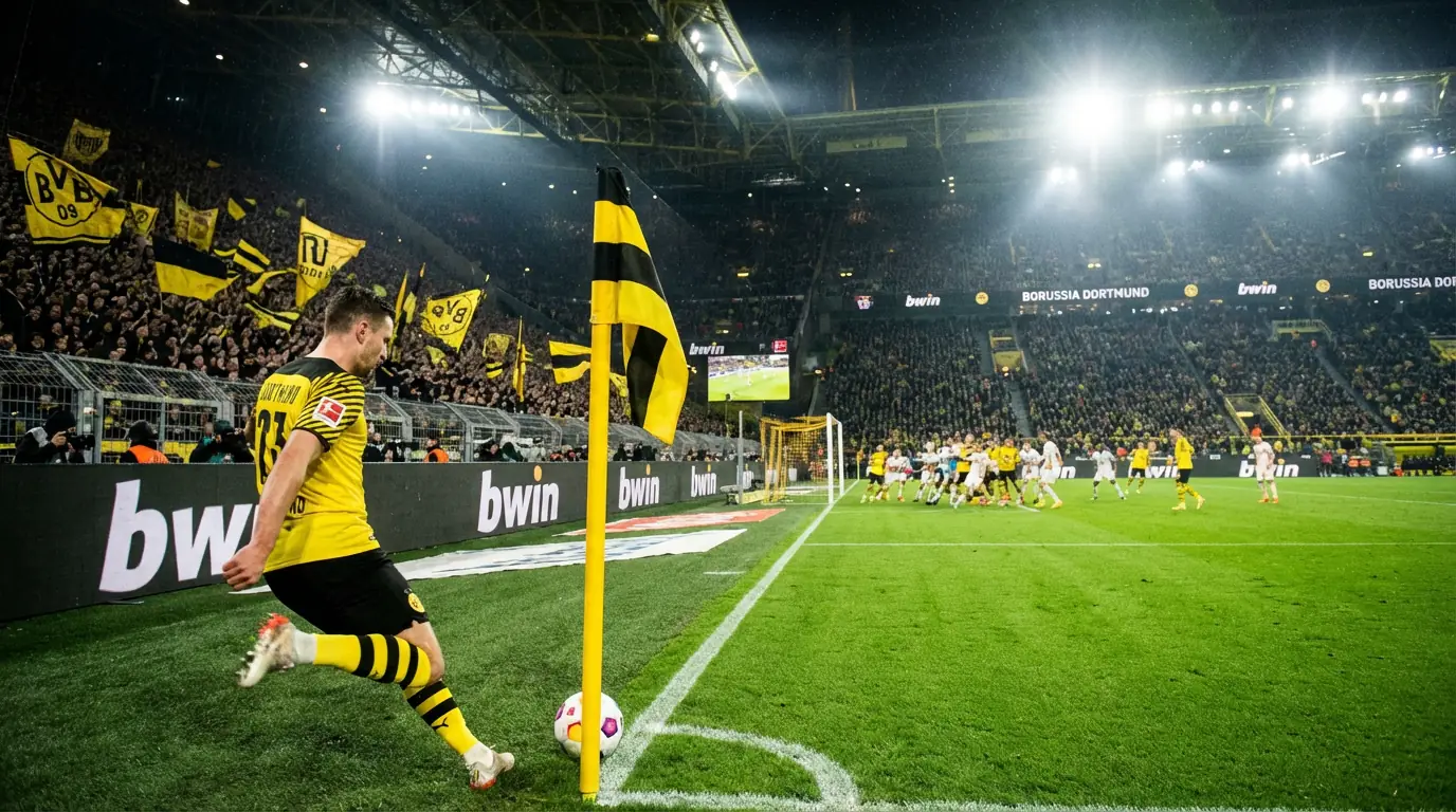 Giocatore di calcio che batte un calcio d'angolo in uno stadio tedesco pieno di tifosi